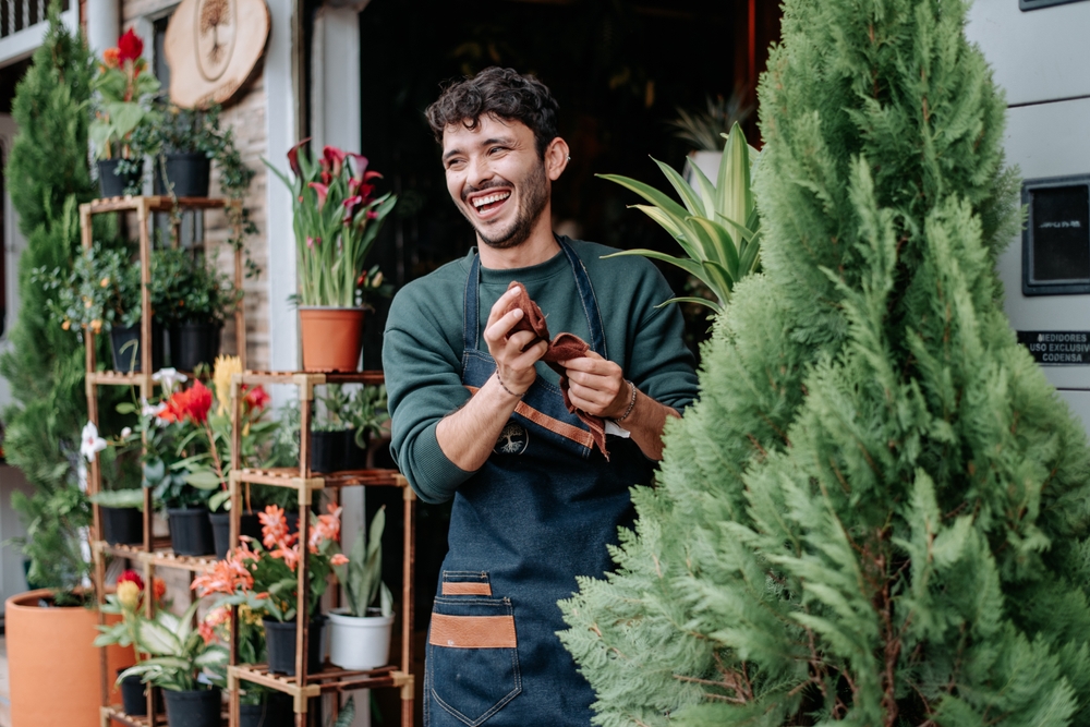 young entrepreneurial man in front of his plant store small business