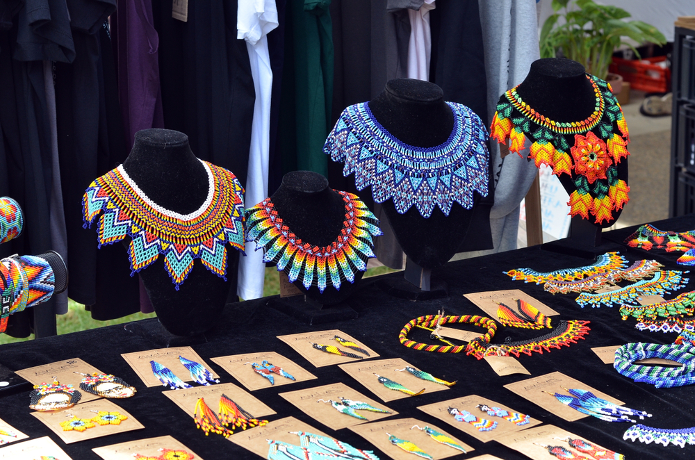 table of vibrant colored jewelry at a craft fair on a table